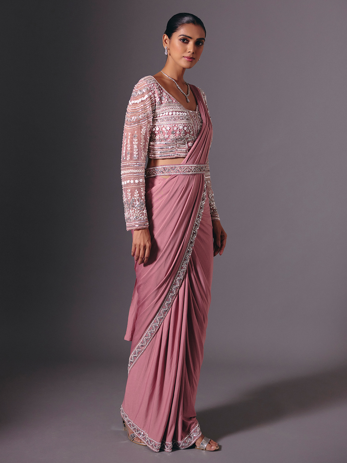 This onion pink lycra saree dazzles with intricate cutdana, sequin, bead, diamond and pearl work. Styled with a chic designer waist belt, it offers a graceful, modern silhouette. Ideal for wedding celebrations, receptions and glamorous parties. - Image 2